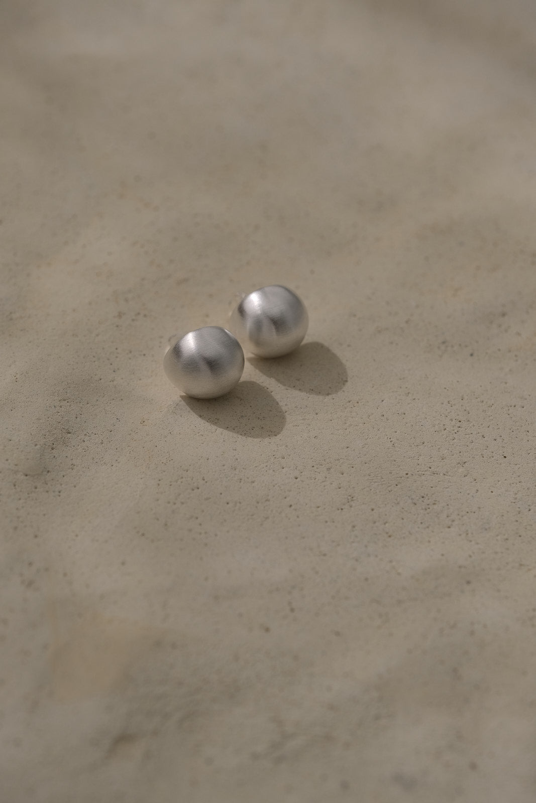 Handmade ONOA earrings in recycled silver with a semi-matte finish, embodying ethical and sustainable jewelry.