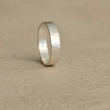 Handmade ISIA big ring in recycled silver with a semi-matte surface and delicately hammered finish.