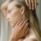 Model wearing the KAYU ring, showcasing ethical handmade jewelry made from recycled gold and silver.