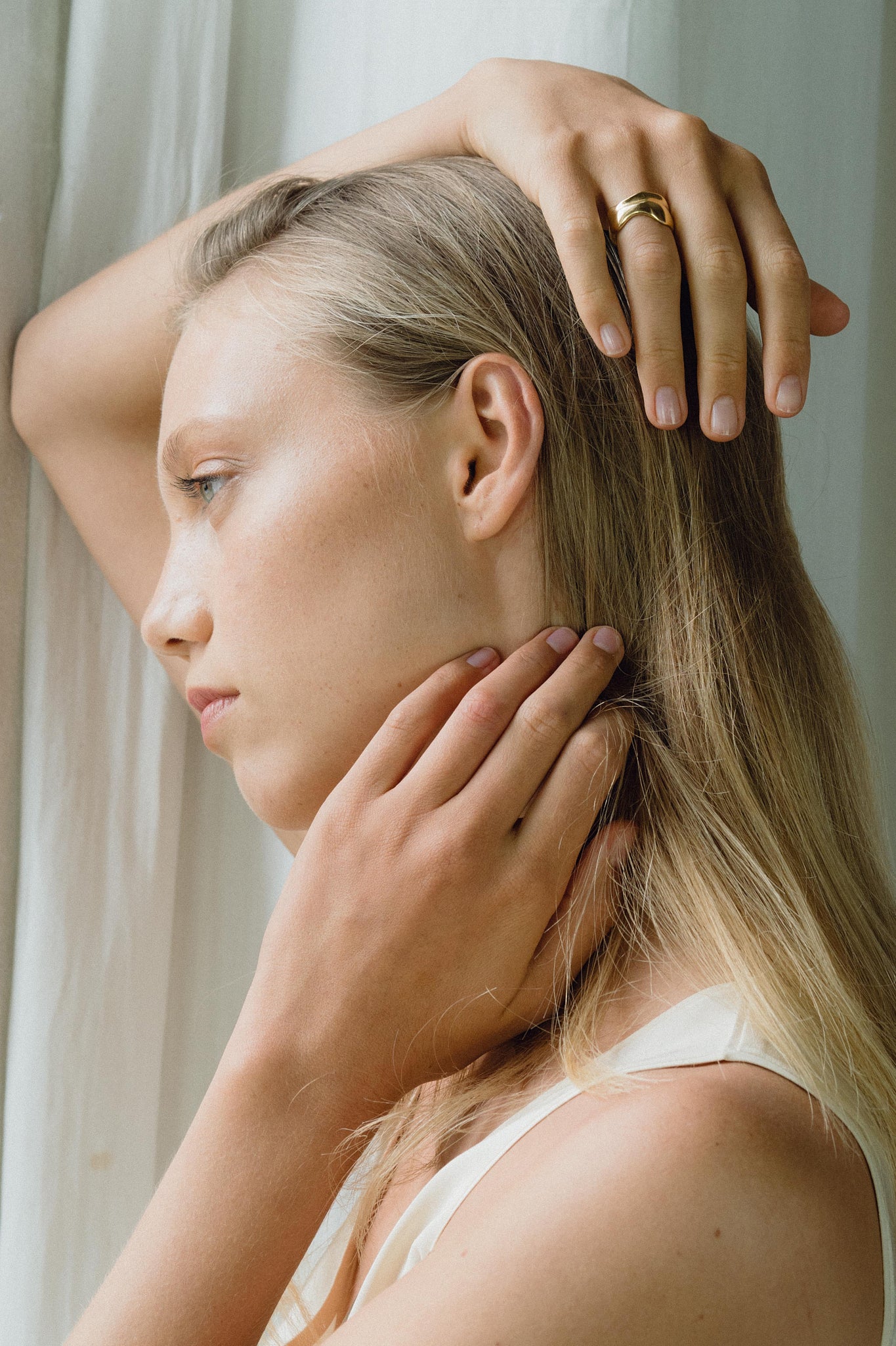 Model wearing the KAYU ring, showcasing ethical handmade jewelry made from recycled gold and silver.