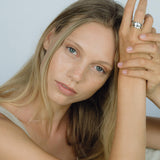 Model showcasing the KAYU ring made from ethical, handmade recycled silver and gold, emphasizing sustainable jewelry.