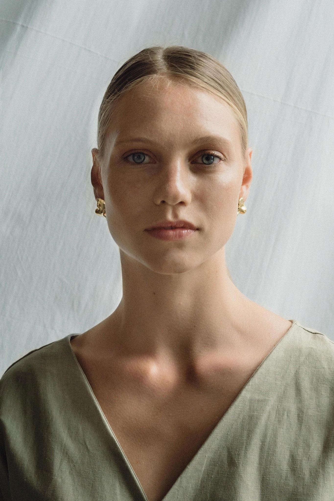Model showcasing MOA earrings, made from recycled gold and silver, emphasizing ethical jewelry and sustainable craftsmanship.