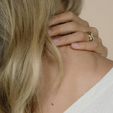 Ethical handmade MOA ring in recycled gold worn by a person, showcasing a natural shiny surface.