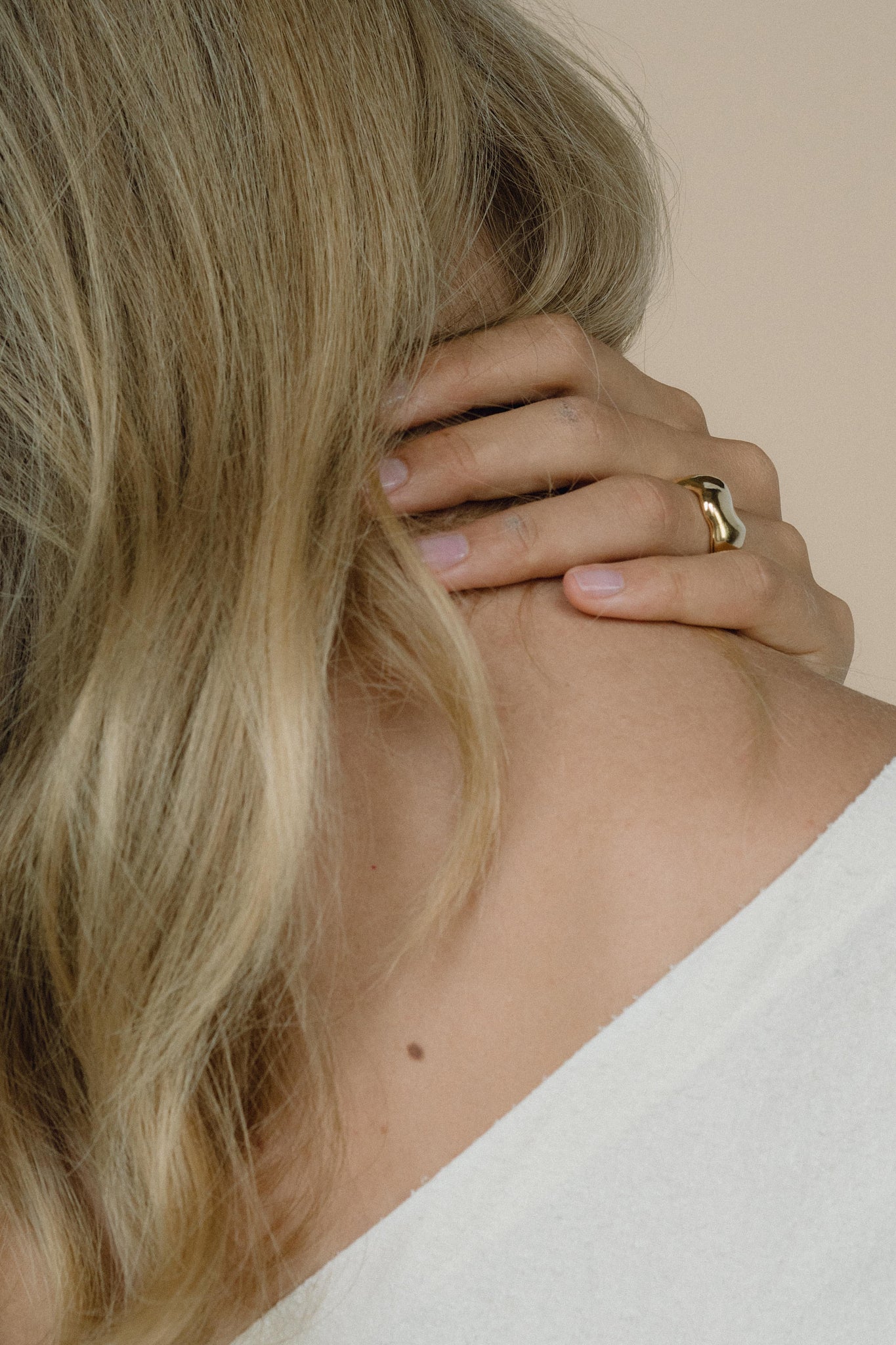 Ethical handmade MOA ring in recycled gold worn by a person, showcasing a natural shiny surface.
