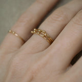 Handcrafted 18k recycled gold TINY PEBBLES ring worn on a hand, showcasing organic design from Basel, Switzerland.