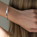 Handmade DROP 04 bracelet in 925 recycled silver, showcasing unique design and sustainable craftsmanship from Basel, Switzerland.