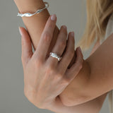 Hand model wearing DROP 04 bracelet and ring made of 925 recycled silver, showcasing unique handmade design in Basel.