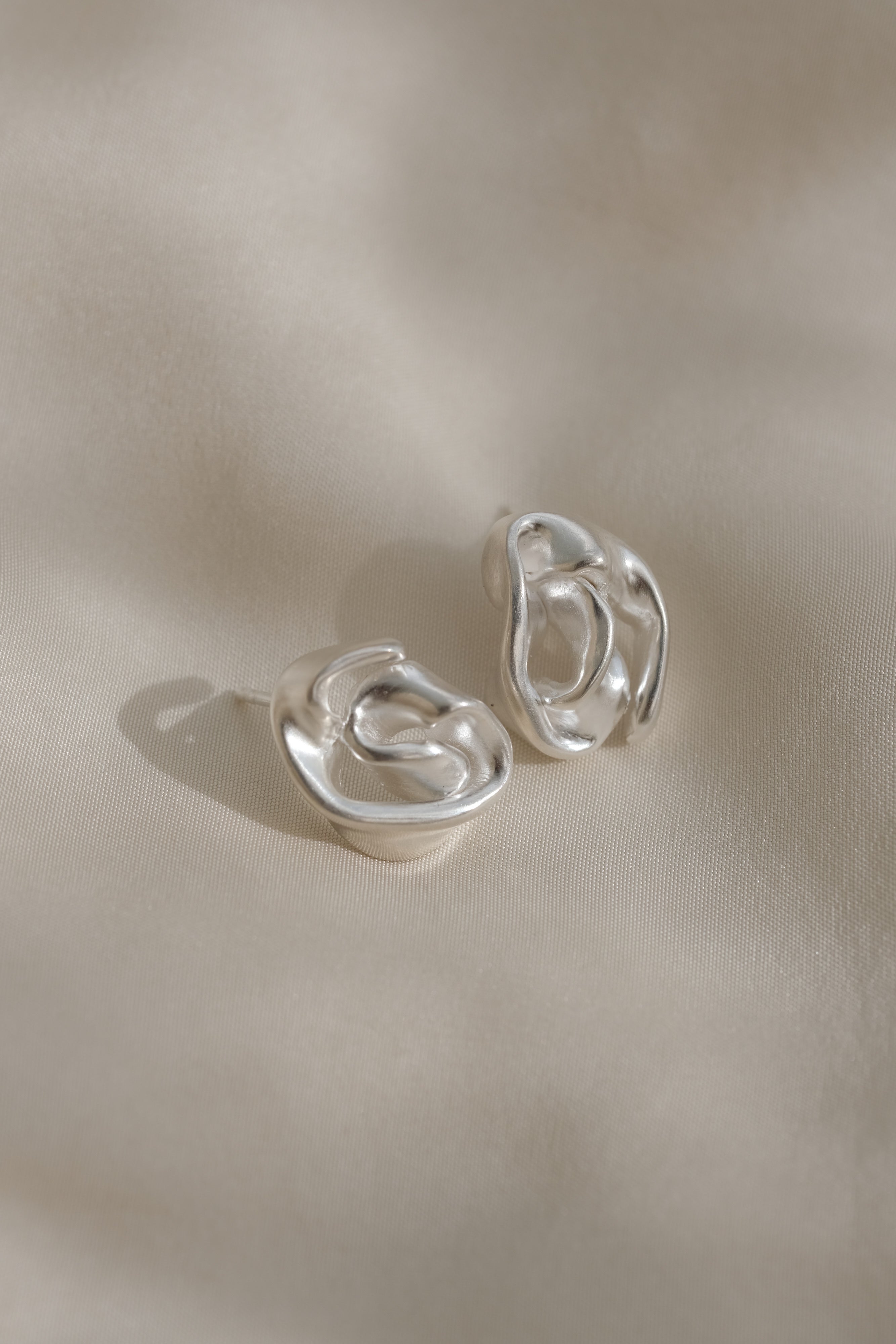 Handmade DROP 04 earrings in 925 recycled silver, featuring unique shapes and satin finish, ethically made in Basel.