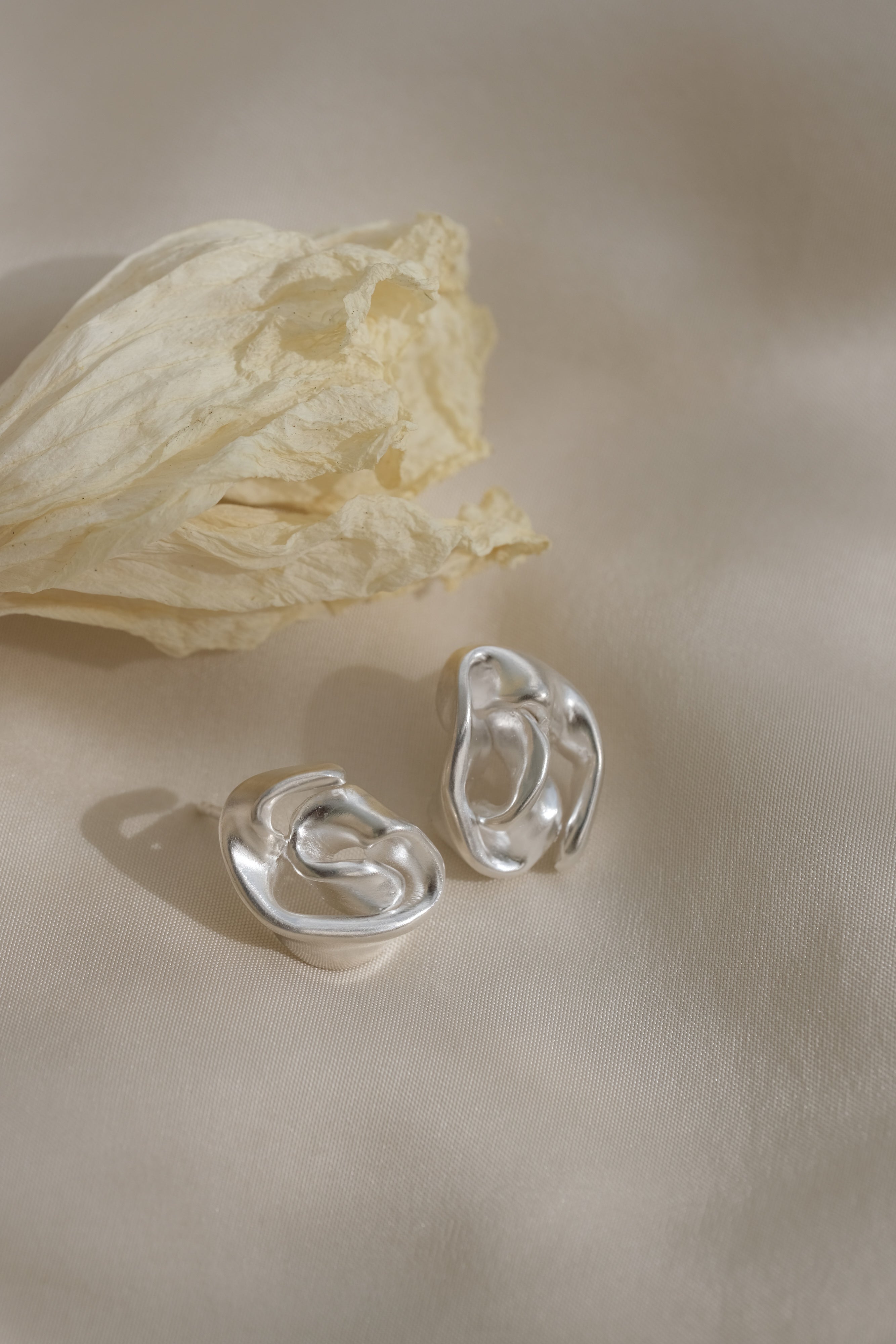 Handmade unique earrings in recycled silver with sustainable design from Basel, Switzerland.