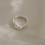 Handmade satin finish ring in recycled silver, designed in Basel, Switzerland, featuring unique characteristics.