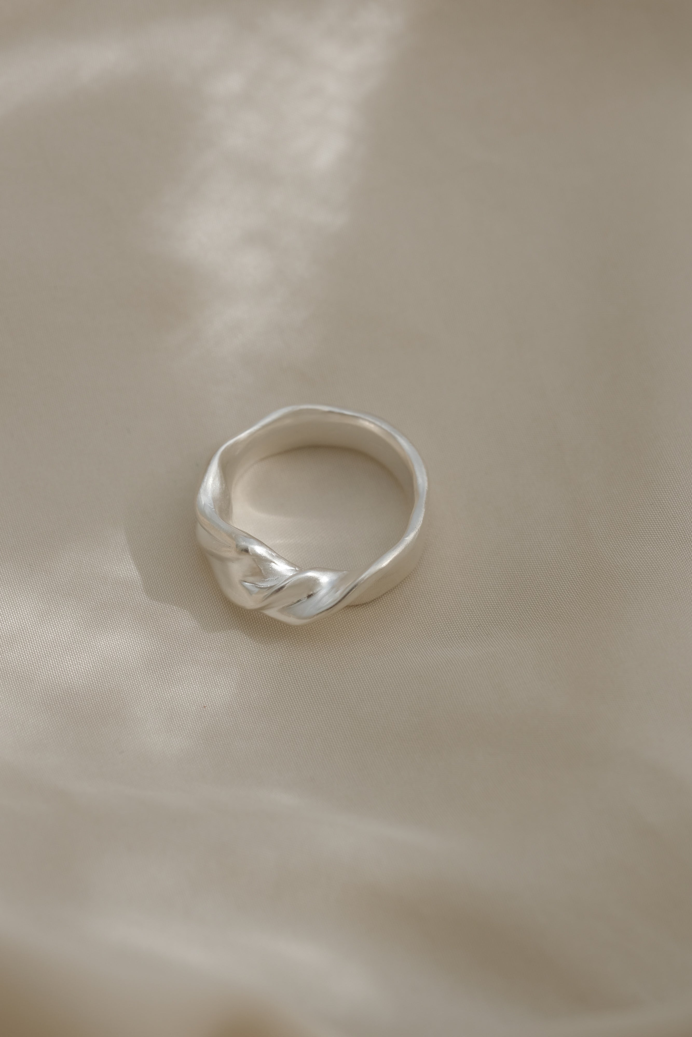 Handmade satin finish ring in recycled silver, designed in Basel, Switzerland, featuring unique characteristics.