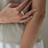 Handcrafted DROP 04 ring in 925 recycled silver worn by a woman, showcasing ethical and unique jewelry made in Basel.