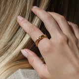 Hand wearing a DROP 04 ring, showcasing ethical and sustainable jewelry handmade in Basel, Switzerland.