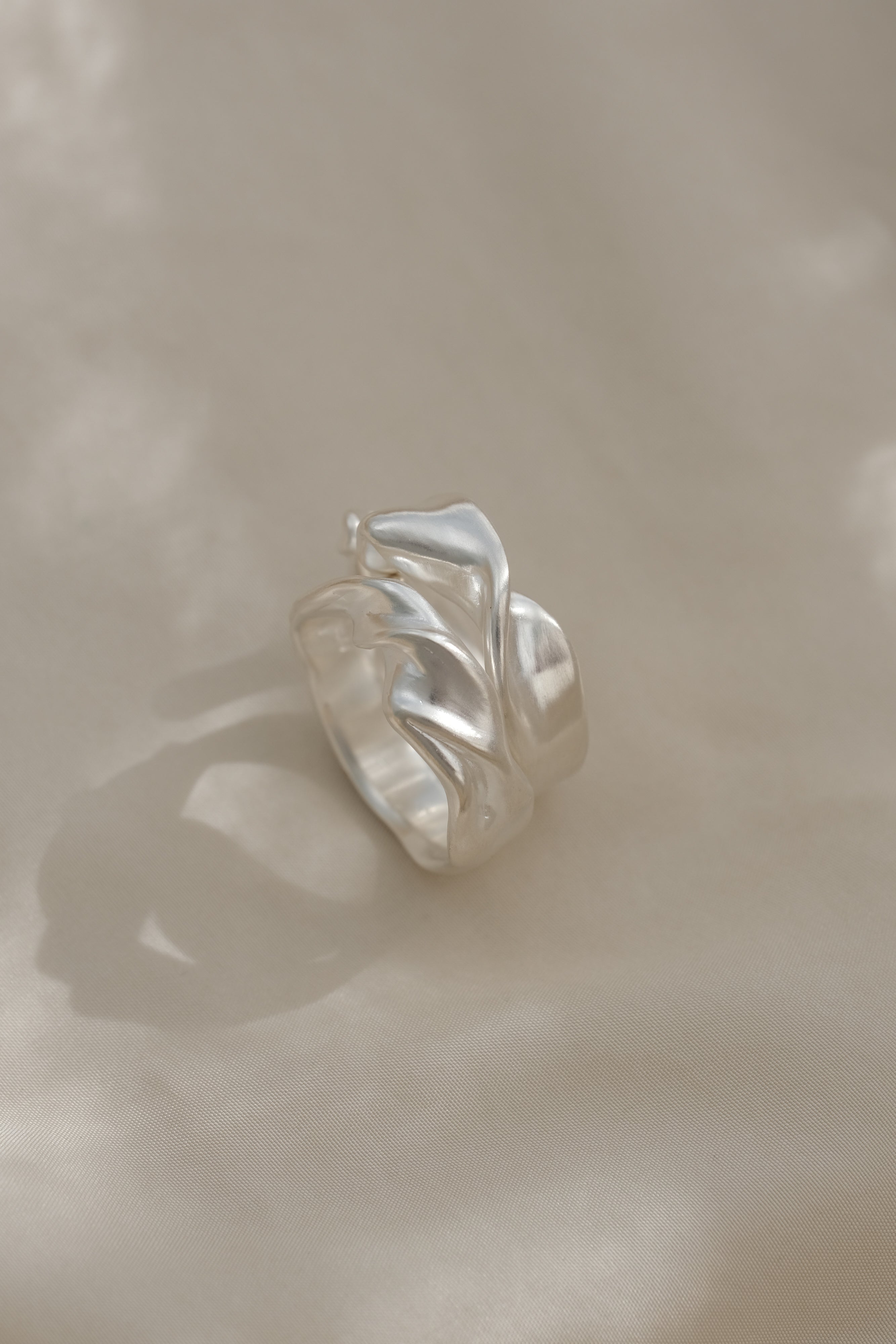 DROP 04 ring four handcrafted in 925 recycled silver, showcasing unique design and satin finish, made in Basel, Switzerland.