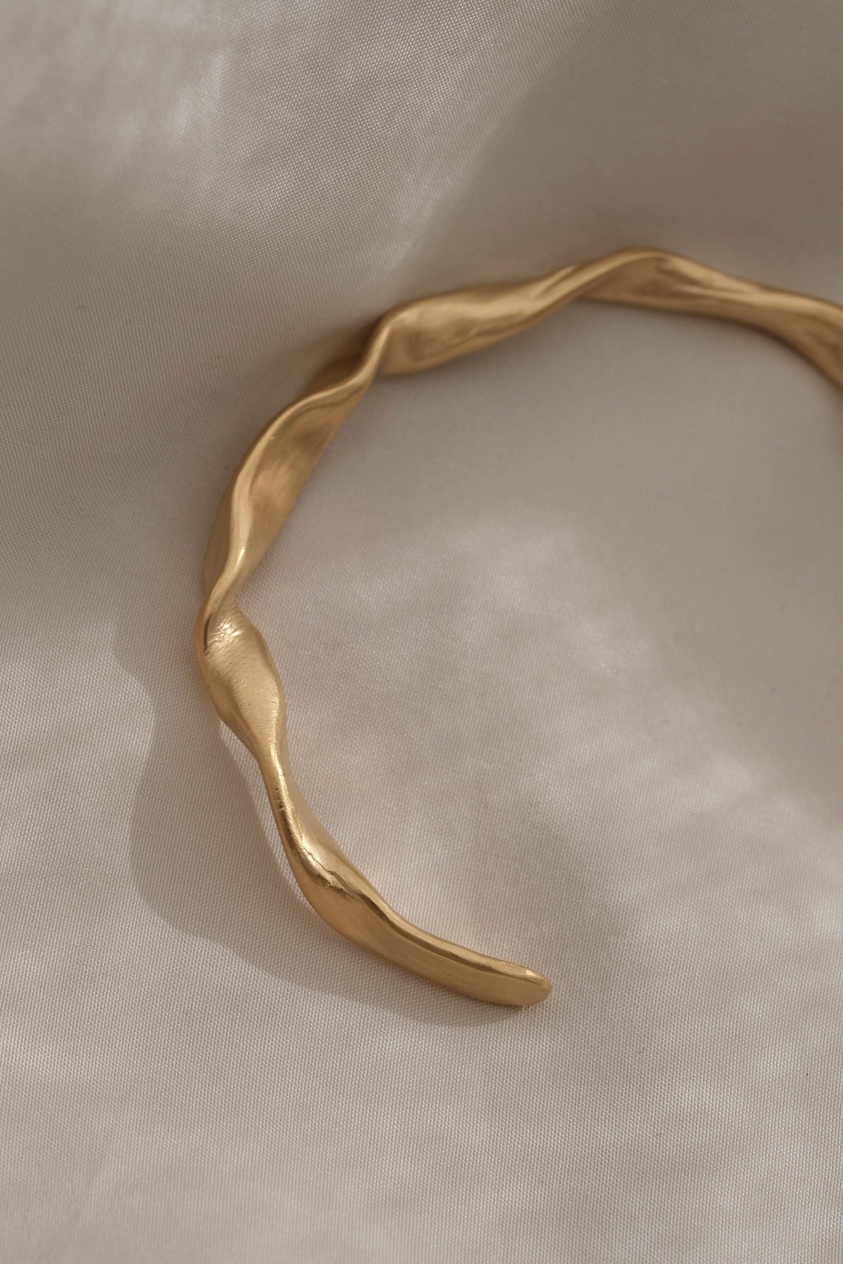Handmade 18k gold-plated bracelet on recycled silver, showcasing unique design and sustainable craftsmanship.