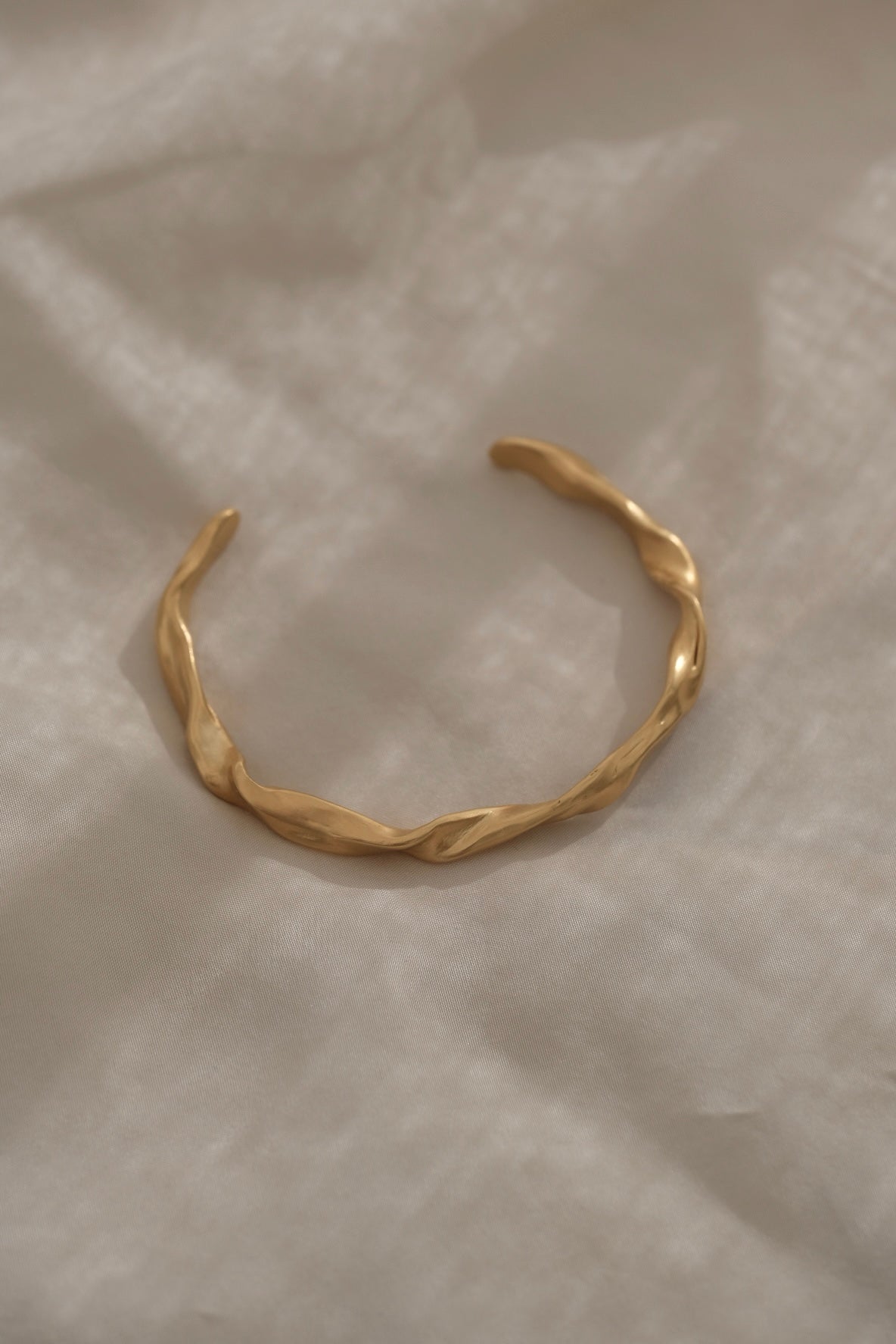 Handmade gold-plated bracelet, ethically crafted in Basel, Switzerland, showcasing unique design and sustainable materials.