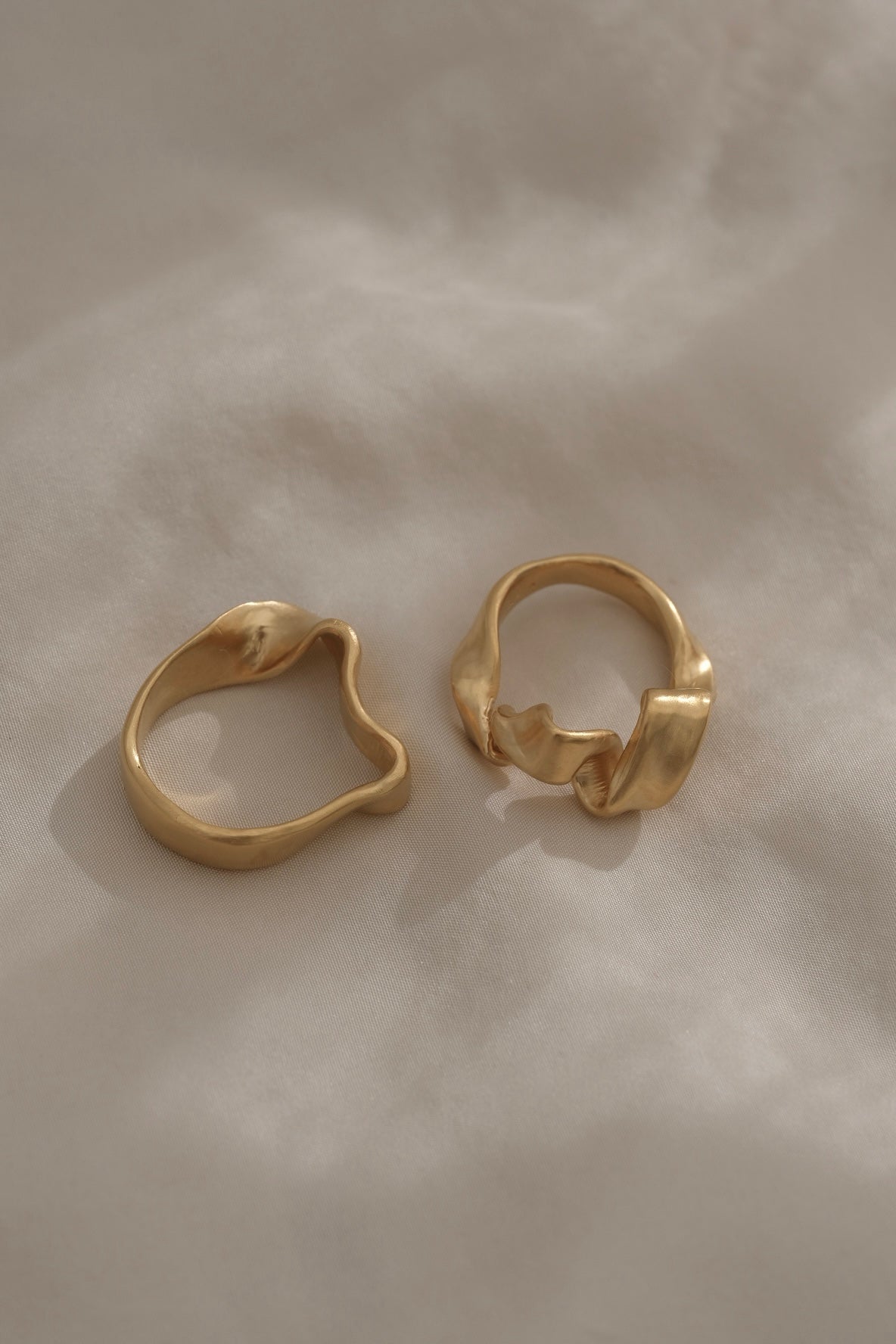 Two unique handmade rings in 18k gold plating, showcasing ethical and sustainable jewelry made in Basel, Switzerland.