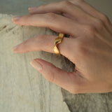 Hand wearing DROP 01 ring two, featuring sustainable 18k gold-plated recycled silver, handmade in Basel.