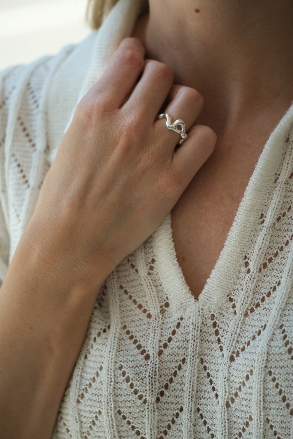 Hand wearing the DROP 02 ring, showcasing unique design in 925 recycled silver, handmade in Basel, Switzerland.