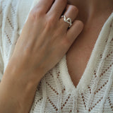 Hand wearing the DROP 02 ring, showcasing unique design in 925 recycled silver, handmade in Basel, Switzerland.