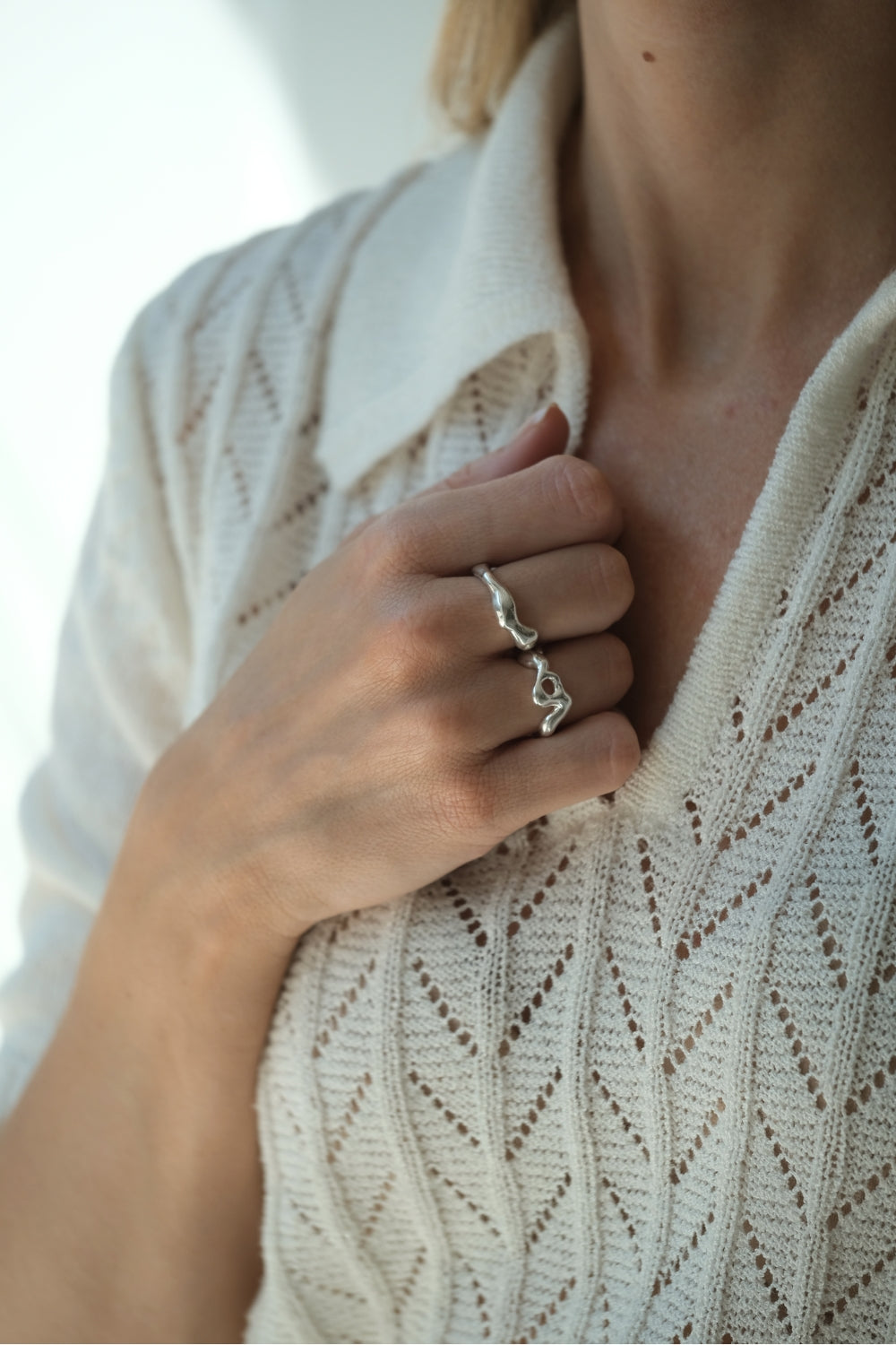 Close-up of a person wearing a handmade DROP 02 ring in recycled silver, embodying ethical and sustainable jewelry.
