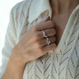 Close-up of a person wearing a handmade DROP 02 ring in recycled silver, embodying ethical and sustainable jewelry.