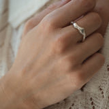 Hand wearing DROP 02 ring made of 925 recycled silver, showcasing unique design and natural shiny finish.