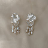Handmade unique earrings with textured design and hanging pearls, crafted from sustainable materials in Basel, Switzerland.