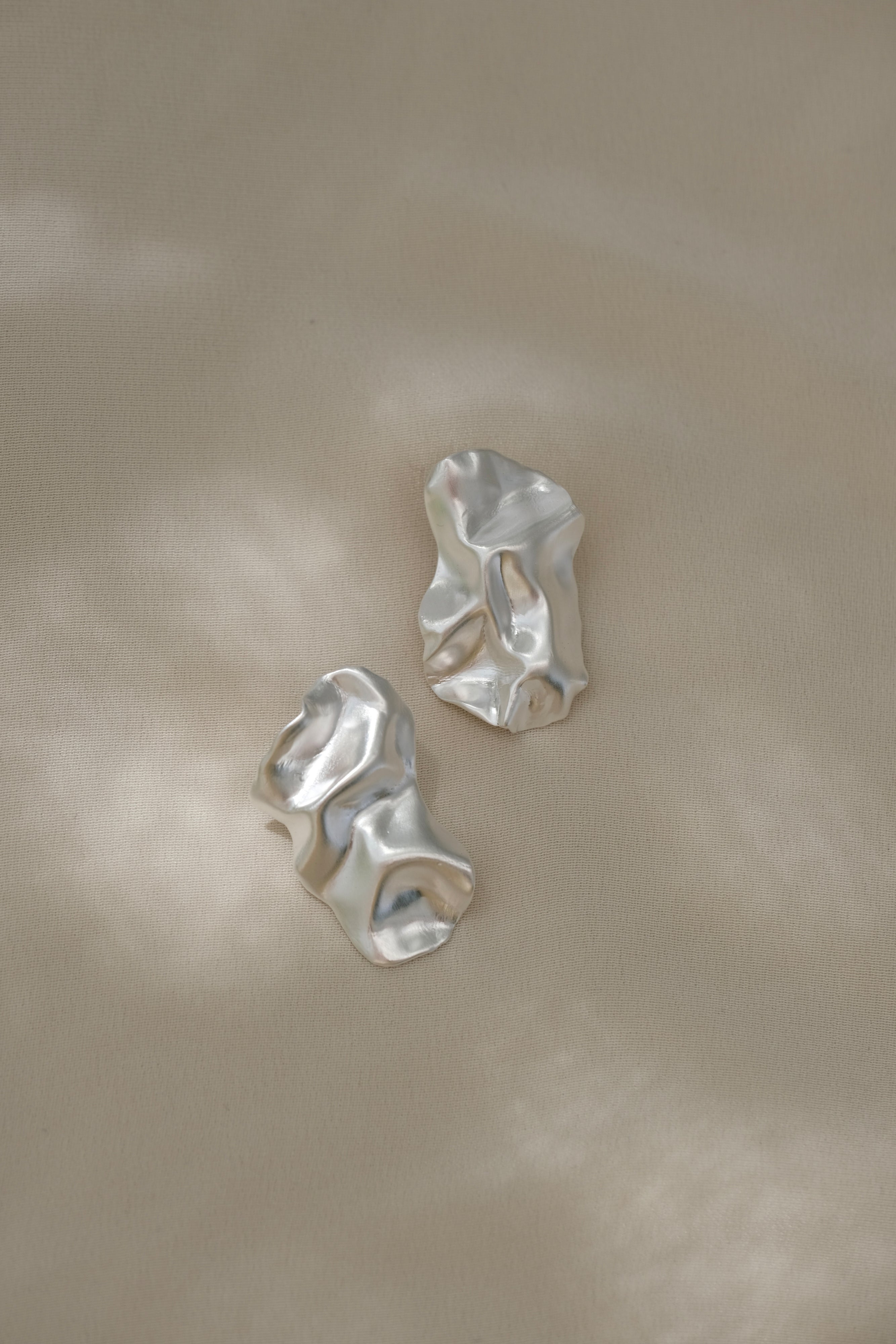 Handmade ethical earrings in recycled silver, featuring a satin finish, shaped in Basel, Switzerland.