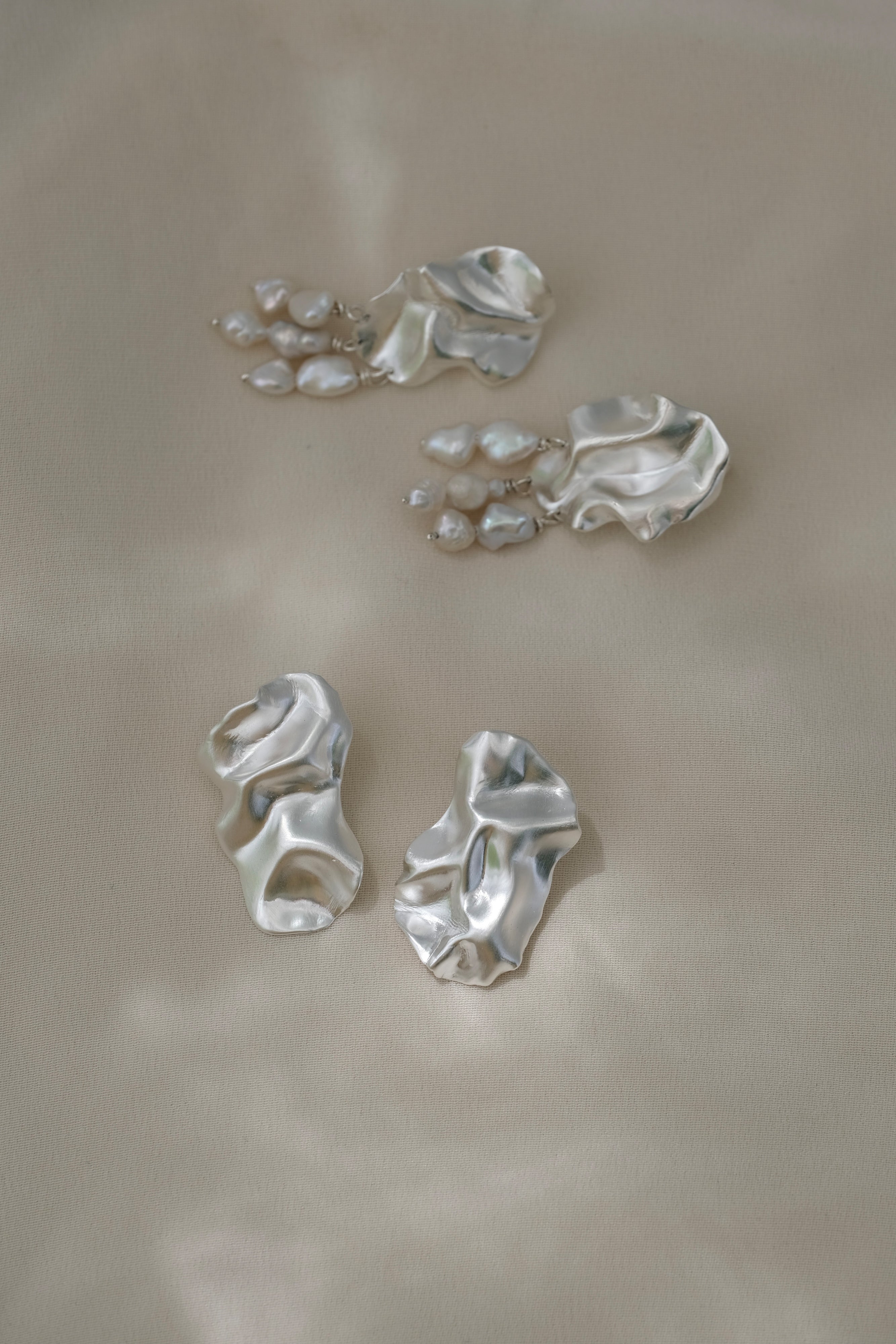 DROP 02 earrings in recycled silver, handmade in Basel, featuring unique satin finish and organic shapes, ethical jewelry.