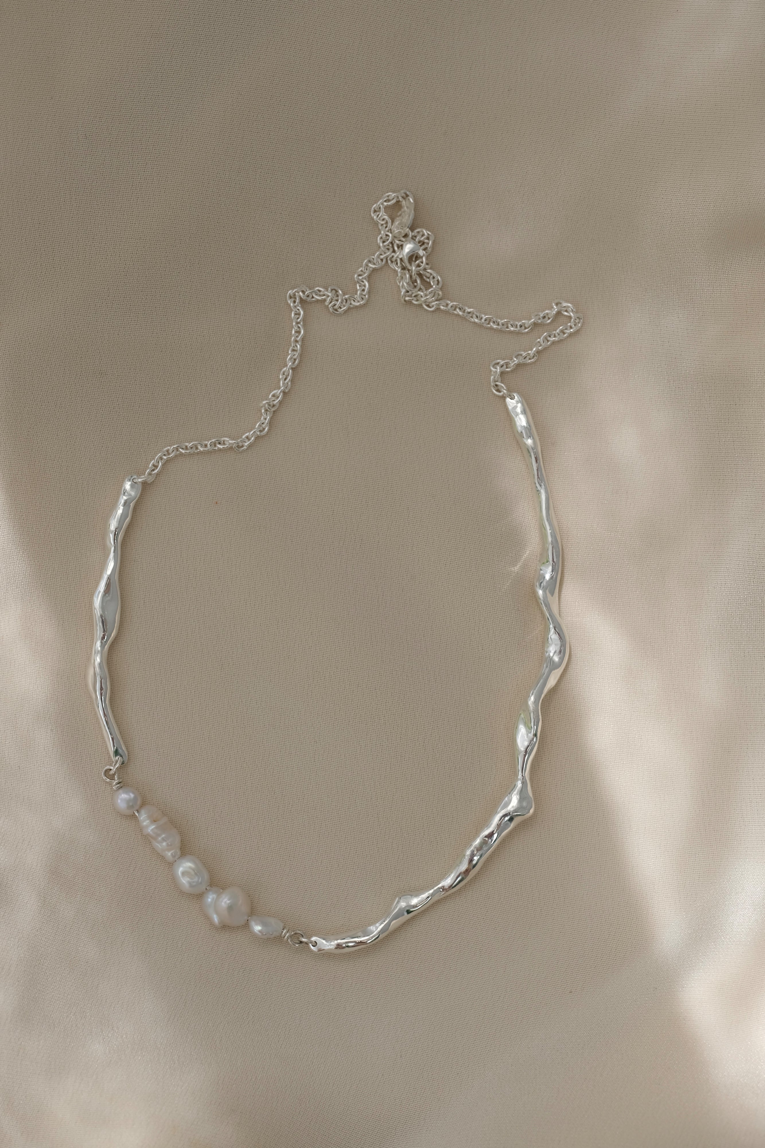 Handmade necklace in 925 recycled silver with unique organic design and natural pearls, showcasing sustainable jewelry craftsmanship.
