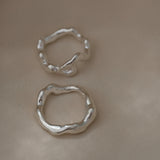 Handmade two-ring set in 925 recycled silver, featuring unique textures, crafted in Basel, Switzerland.