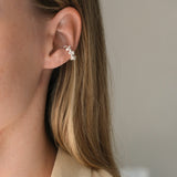 Close-up of a woman wearing a handmade ear cuff in 925 recycled silver, showcasing ethical jewelry design in Basel, Switzerland.