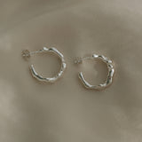 Handmade silver hoop earrings, ethical and sustainable jewelry, crafted in Basel, Switzerland, showcasing unique design.