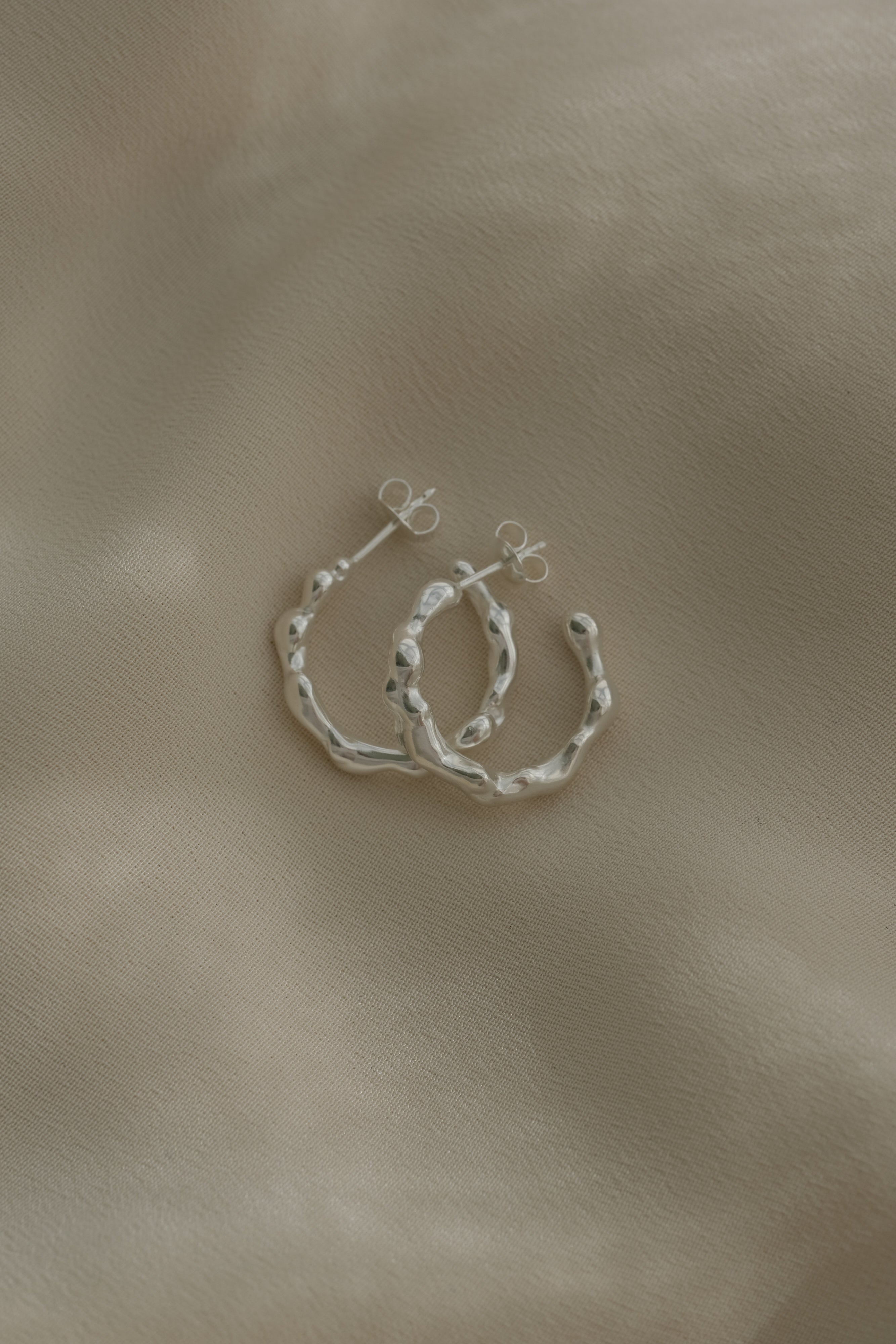 Handmade 925 recycled silver earrings from Basel, showcasing unique, ethical, and sustainable jewelry craftsmanship.