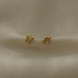 Handmade earrings in recycled yellow gold, showcasing ethical and sustainable jewelry design from Basel, Switzerland.