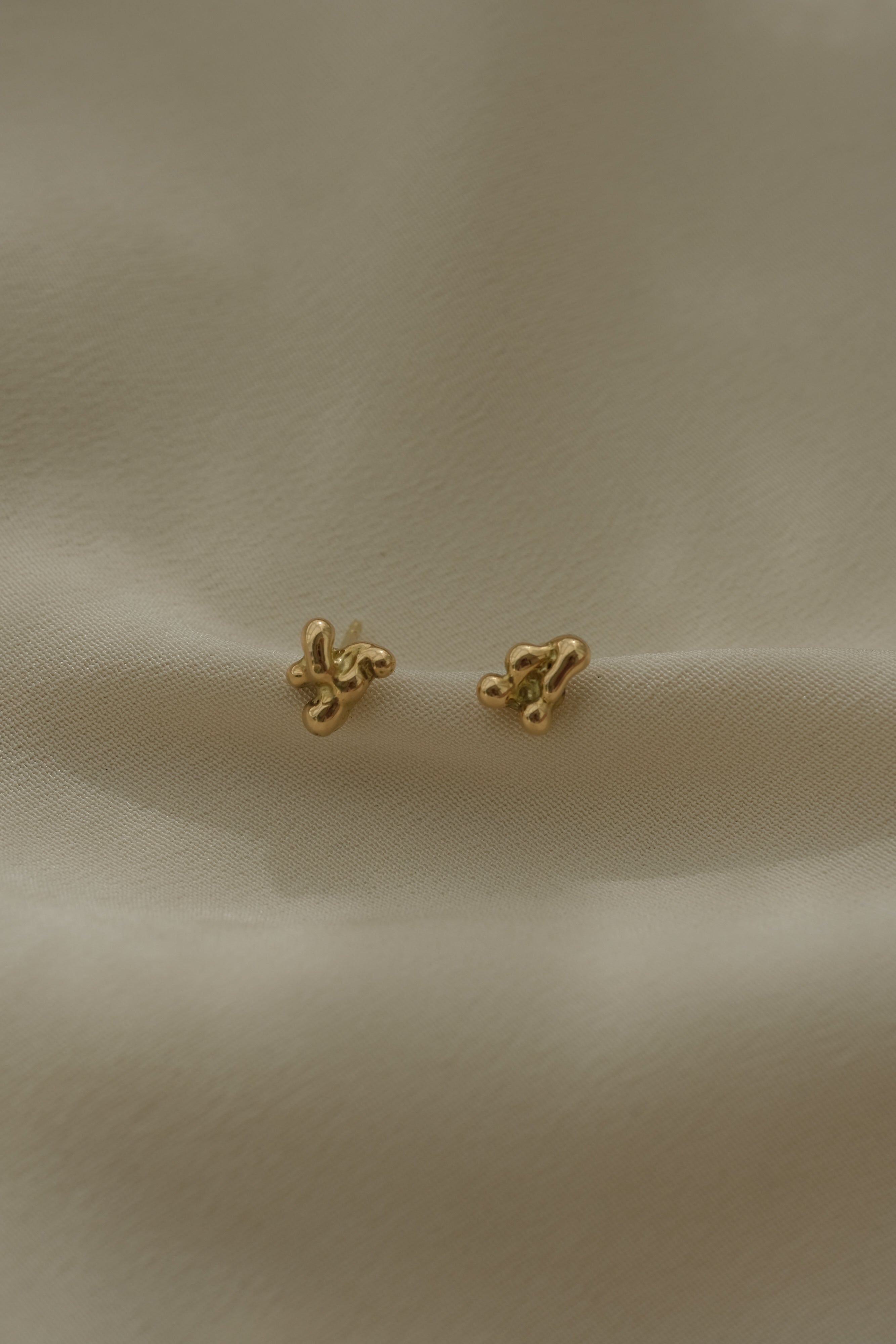 Handmade earrings in recycled yellow gold, showcasing ethical and sustainable jewelry design from Basel, Switzerland.