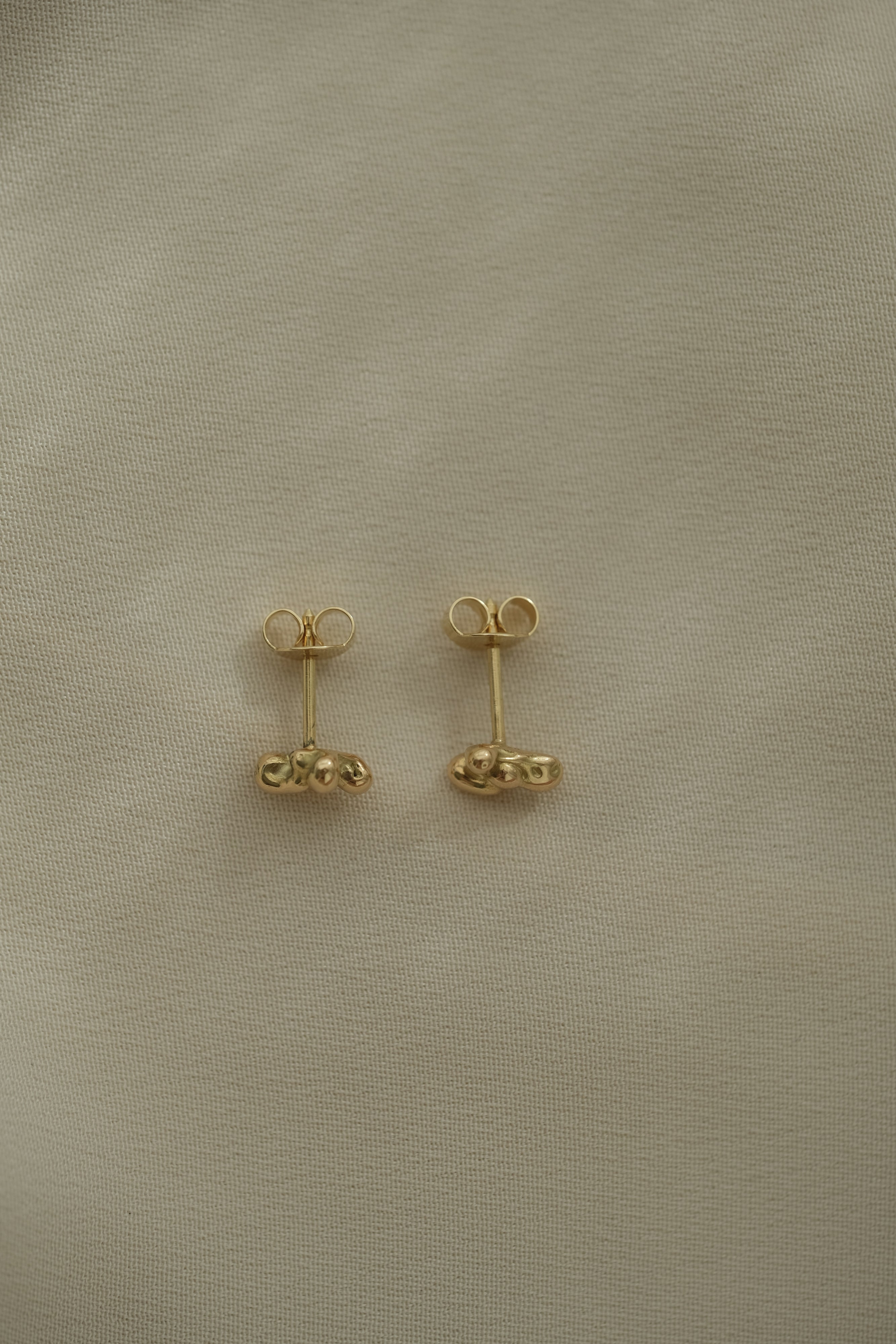 Handmade ethical earrings in 18k recycled yellow gold, designed in Basel, Switzerland, featuring a unique, shiny finish.