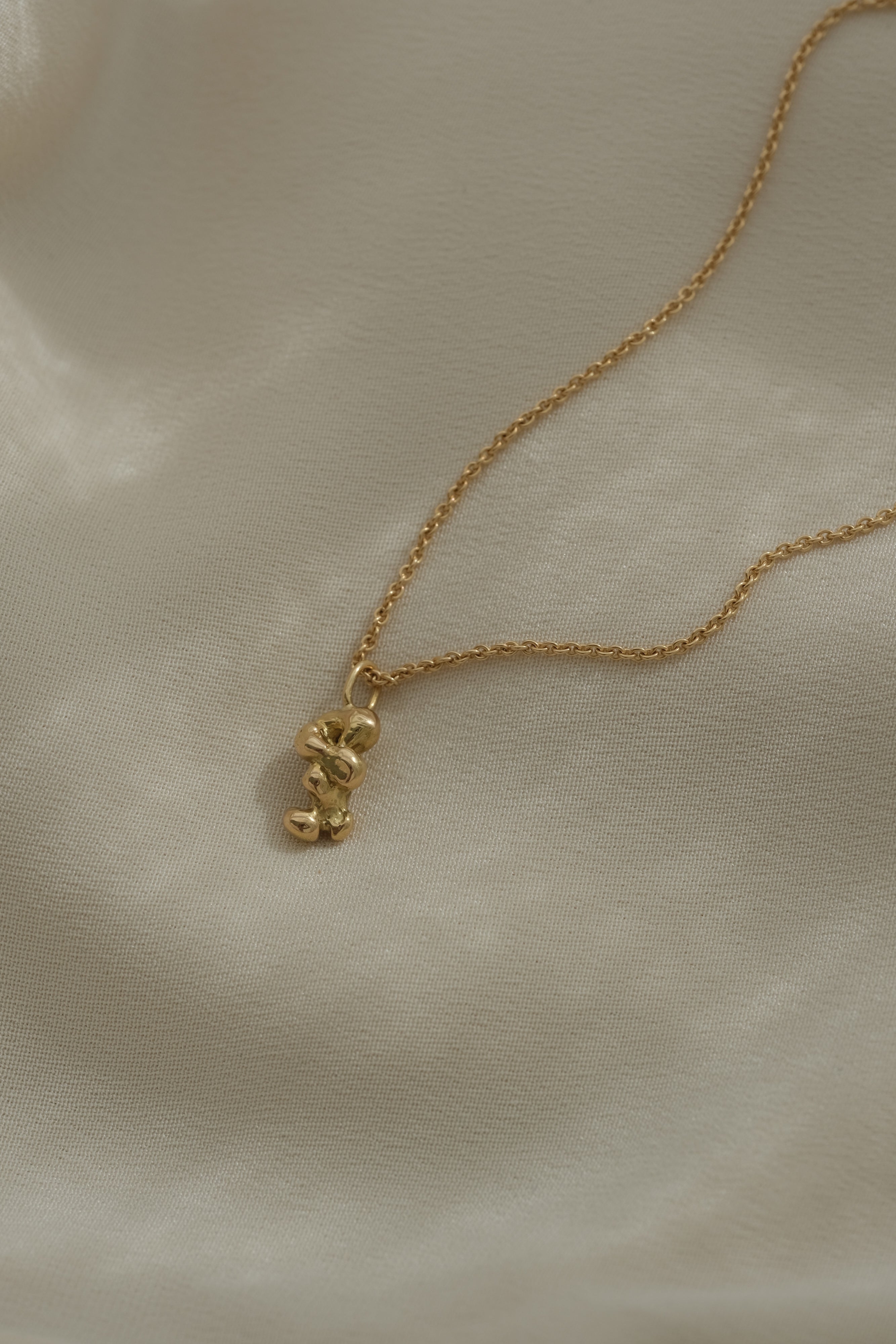 Handmade ethical 18k recycled gold necklace with unique pendant, designed in Basel, Switzerland.