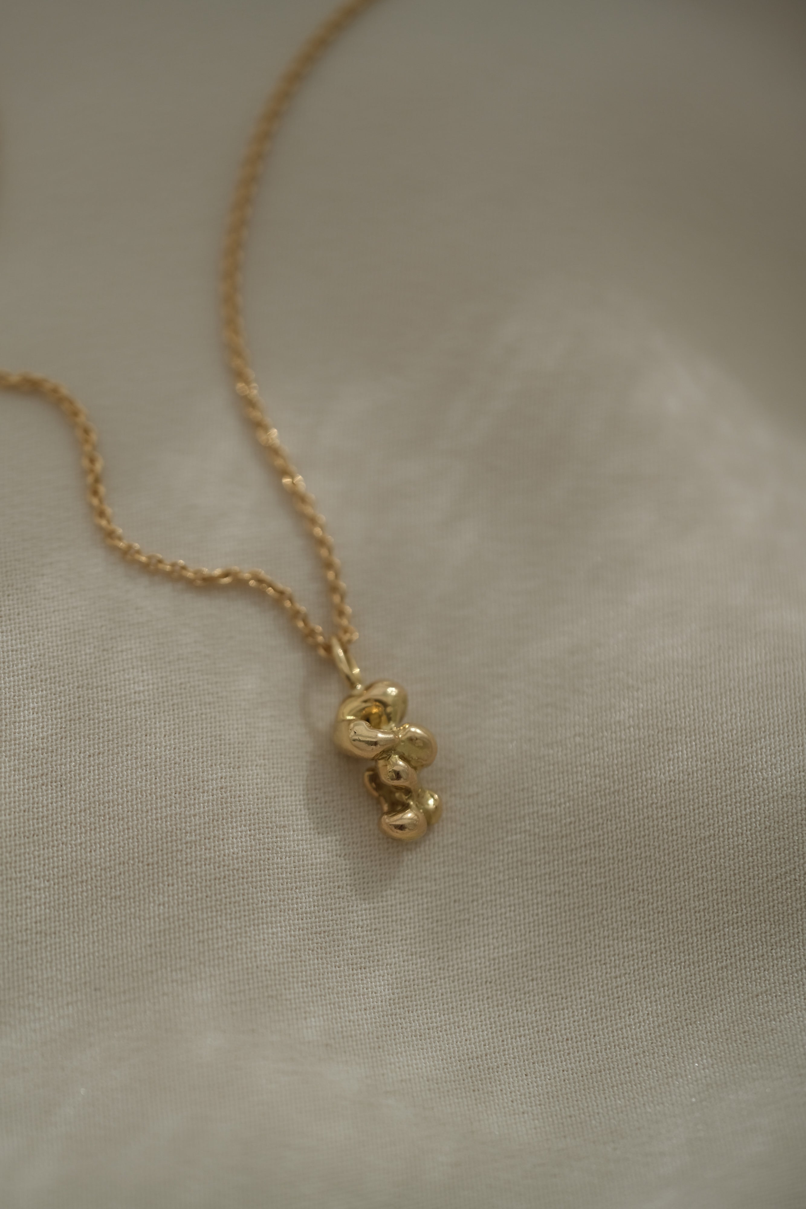 Handmade ethical necklace in recycled 18k gold, unique jewelry crafted in Basel, Switzerland.