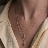 Handmade ethical jewelry featuring two delicate gold necklaces, showcasing craftsmanship from Basel, Switzerland.