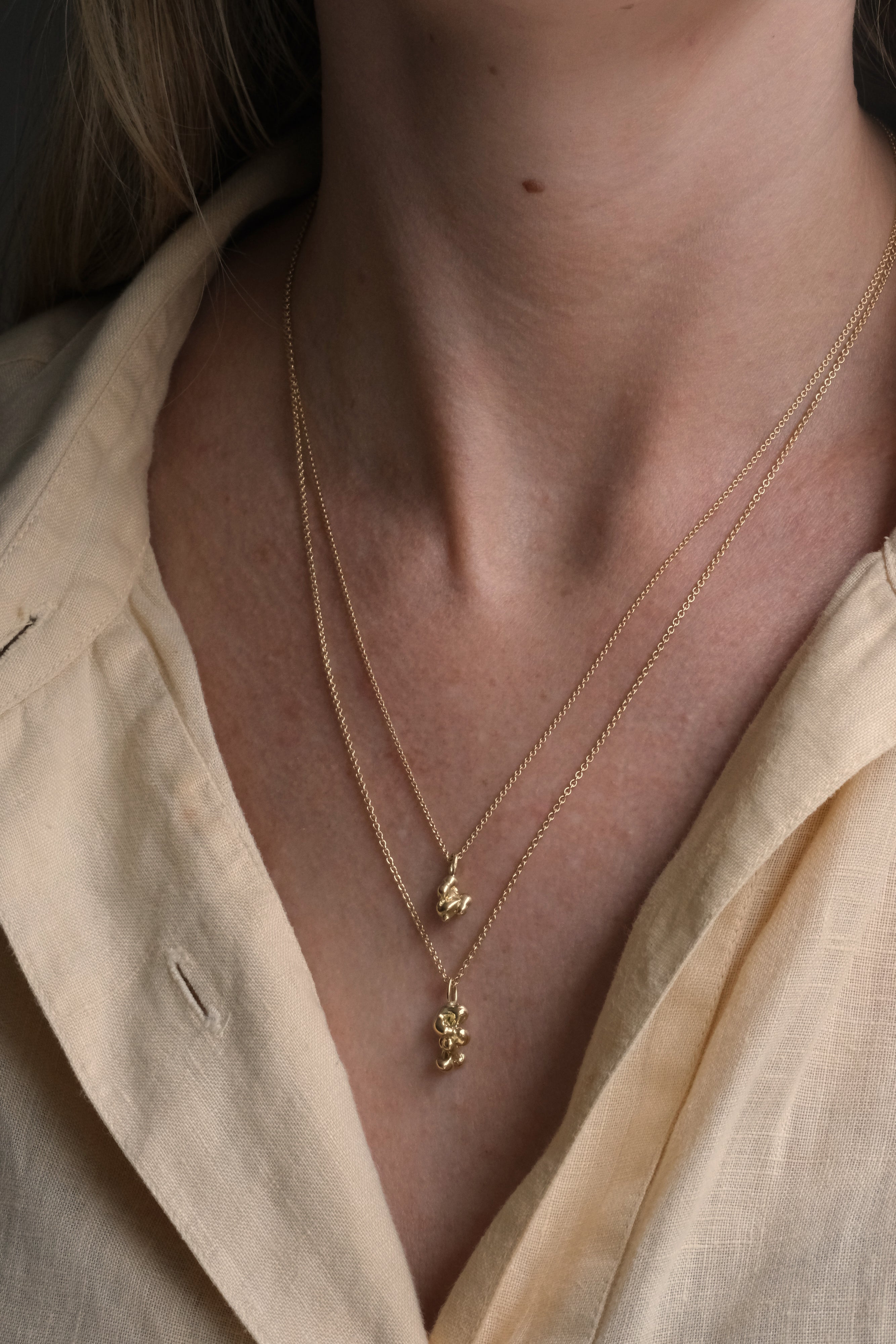 Handmade ethical jewelry featuring two delicate gold necklaces, showcasing craftsmanship from Basel, Switzerland.