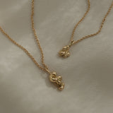 Handmade ethical and sustainable jewelry, featuring two unique necklaces in recycled 18k yellow gold from Basel, Switzerland.