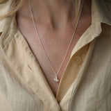 Handmade DROP 03 necklace in 925 recycled silver, worn with a light yellow shirt, showcasing ethical jewelry craftsmanship.