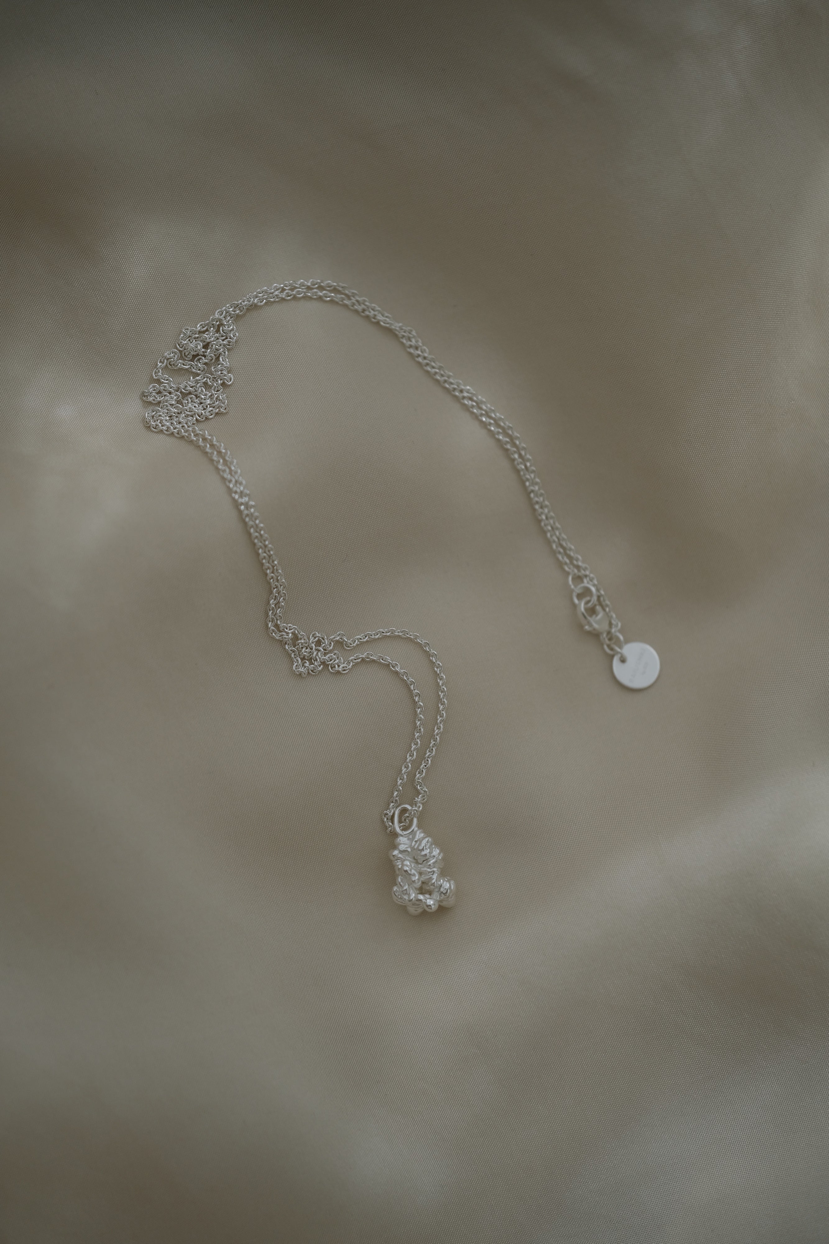 Unique handmade necklace featuring a satin-finished pendant in 925 recycled silver, crafted in Basel, Switzerland.