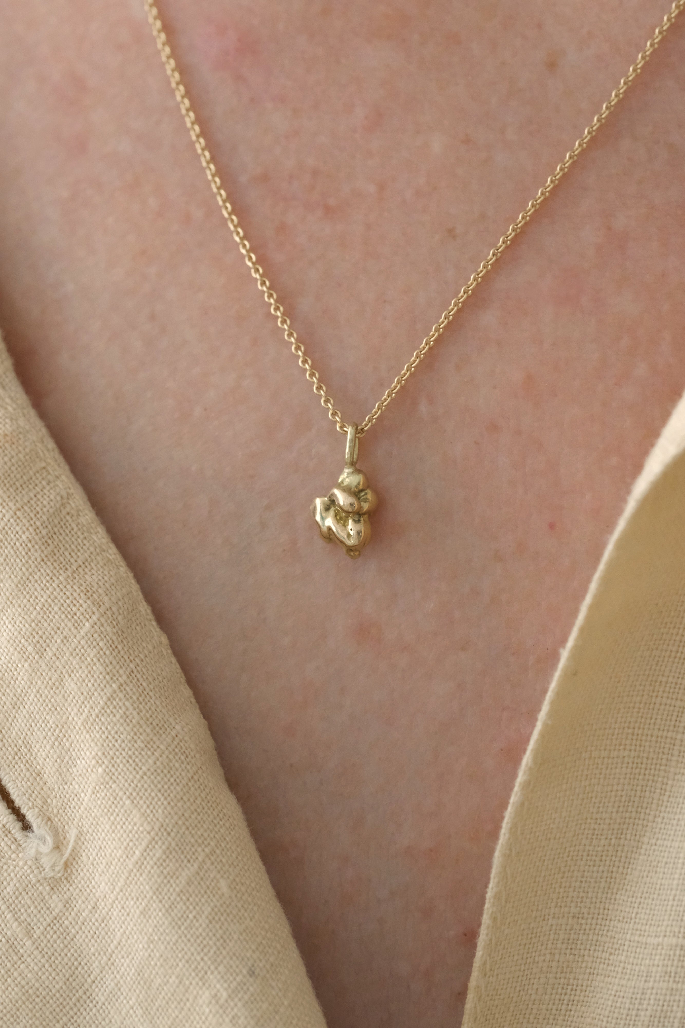 Handmade ethical necklace in 18k recycled gold, featuring unique pendant, designed in Basel, Switzerland.