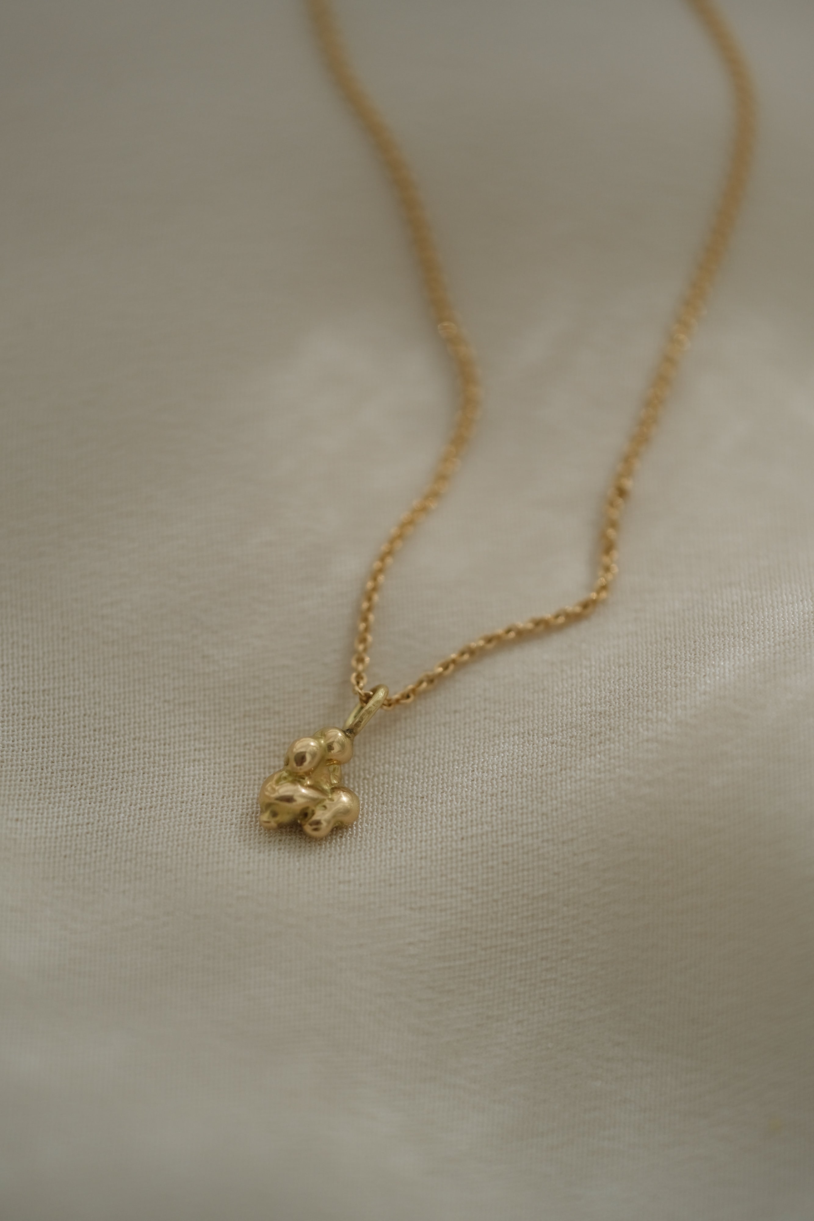DROP 03 necklace handcrafted in Basel, Switzerland with recycled yellow gold, showcasing unique ethical design.