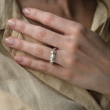 Hand wearing the DROP 03 ring in 925 recycled silver, showcasing unique, ethical jewelry from Basel, Switzerland.
