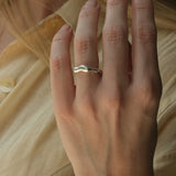 Hand wearing DROP 03 ring in 925 recycled silver, handcrafted in Basel, Switzerland, showcasing unique design.