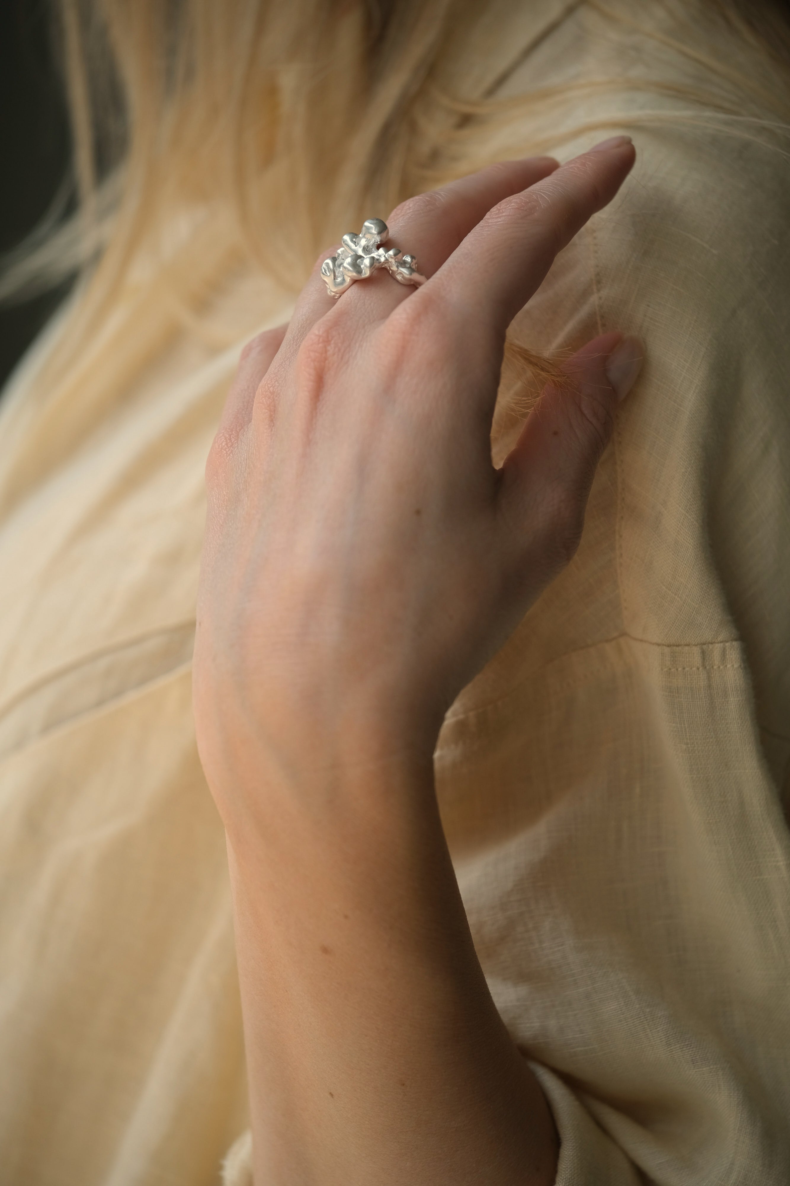 Hand modeling DROP 03 ring one, handmade in Basel with ethical and sustainable materials, featuring unique design characteristics.
